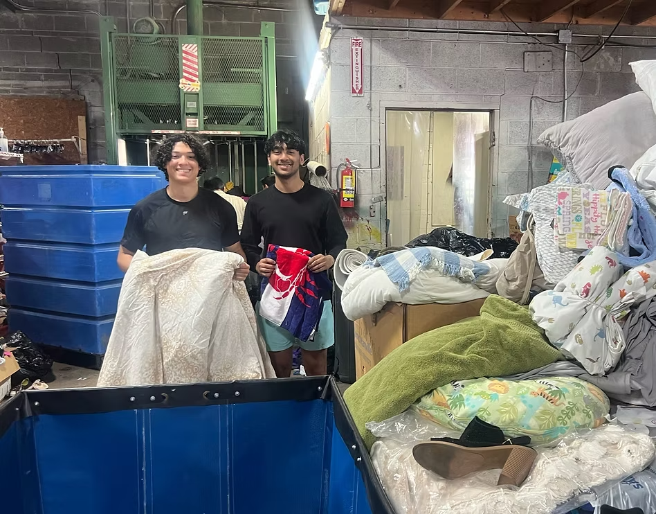 Members sorting donated linens at a community donation center