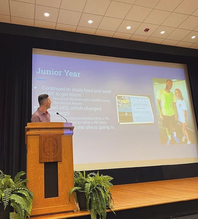 Speaker sharing his path to PA school at an AED chapter