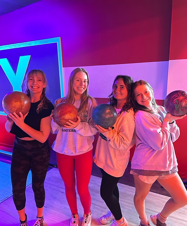 Members holding bowling balls at an AED bowling night