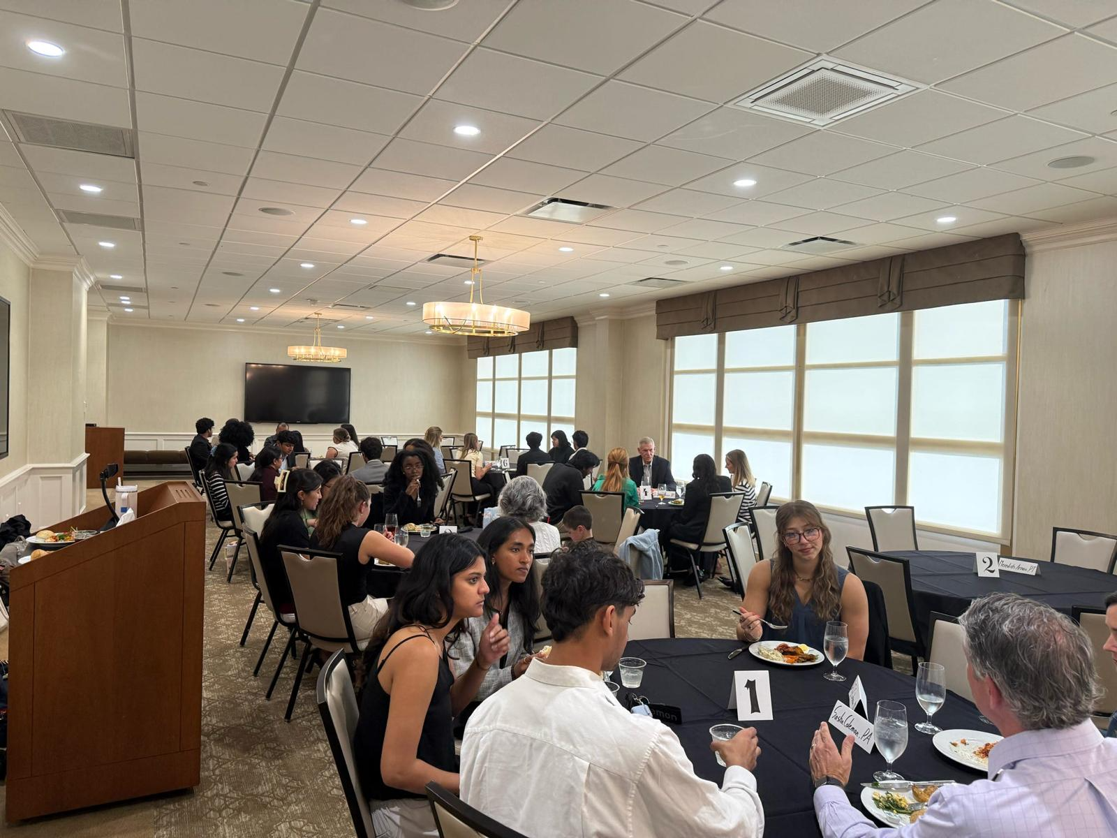 Members networking with professionals during the mixer dinner