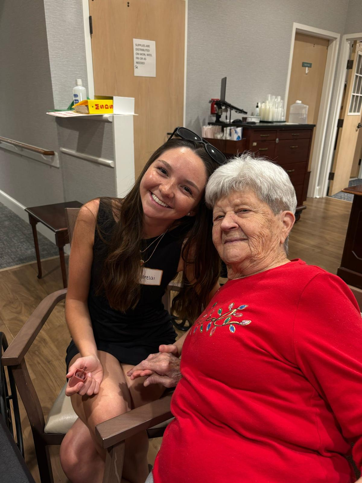 Member visiting with a resident at a senior living center