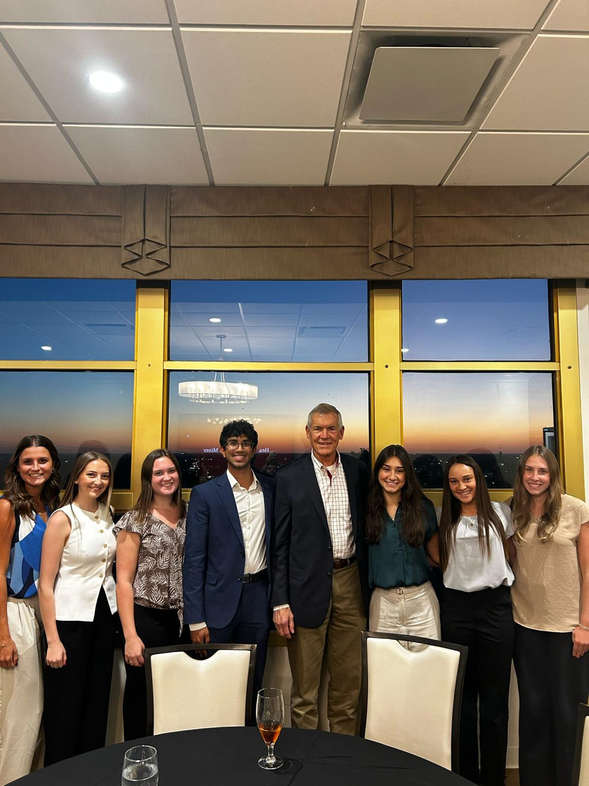 Members with a health professional at the mixer at sunset