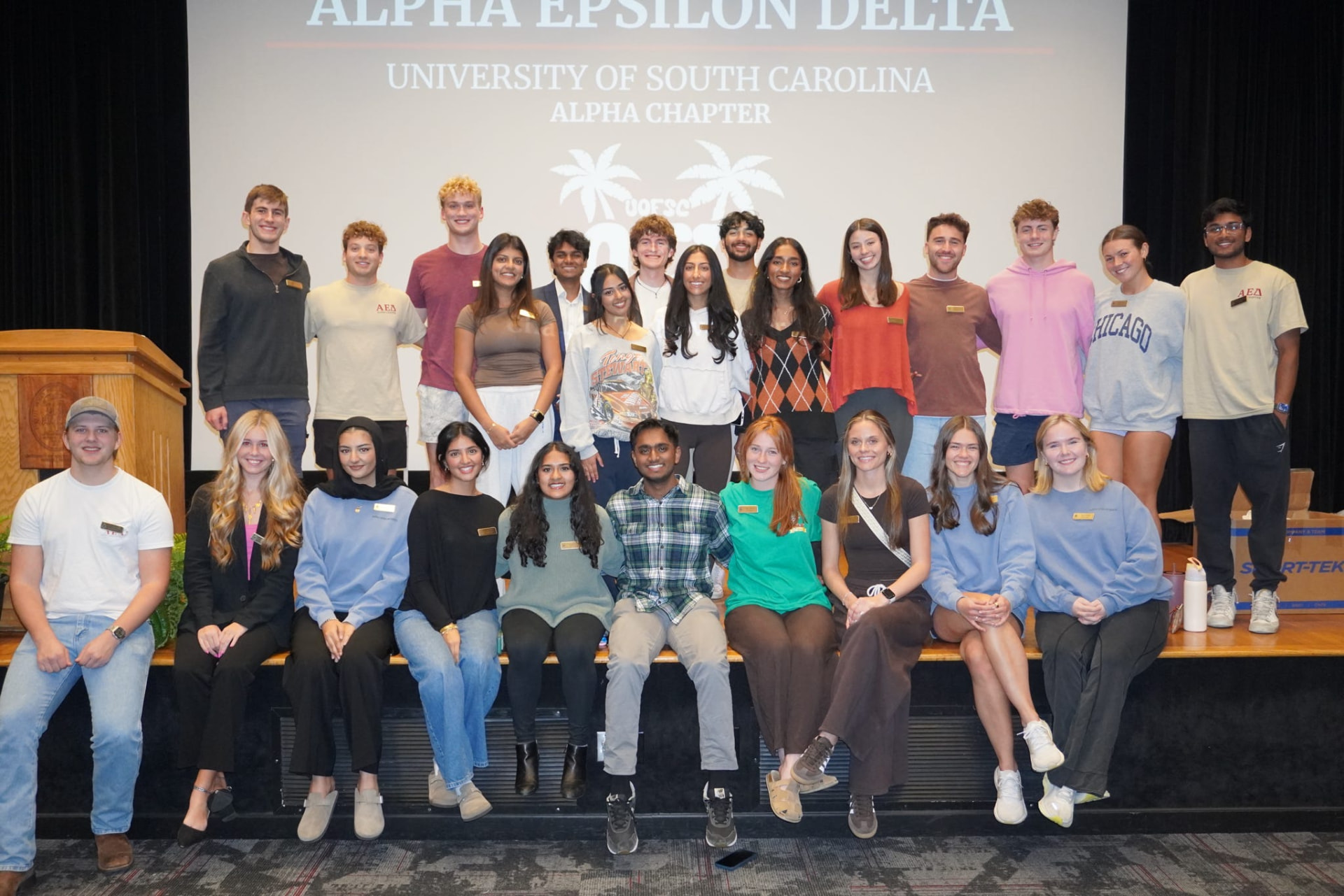 South Carolina Alpha Chapter members gathered on stage beneath the AED banner