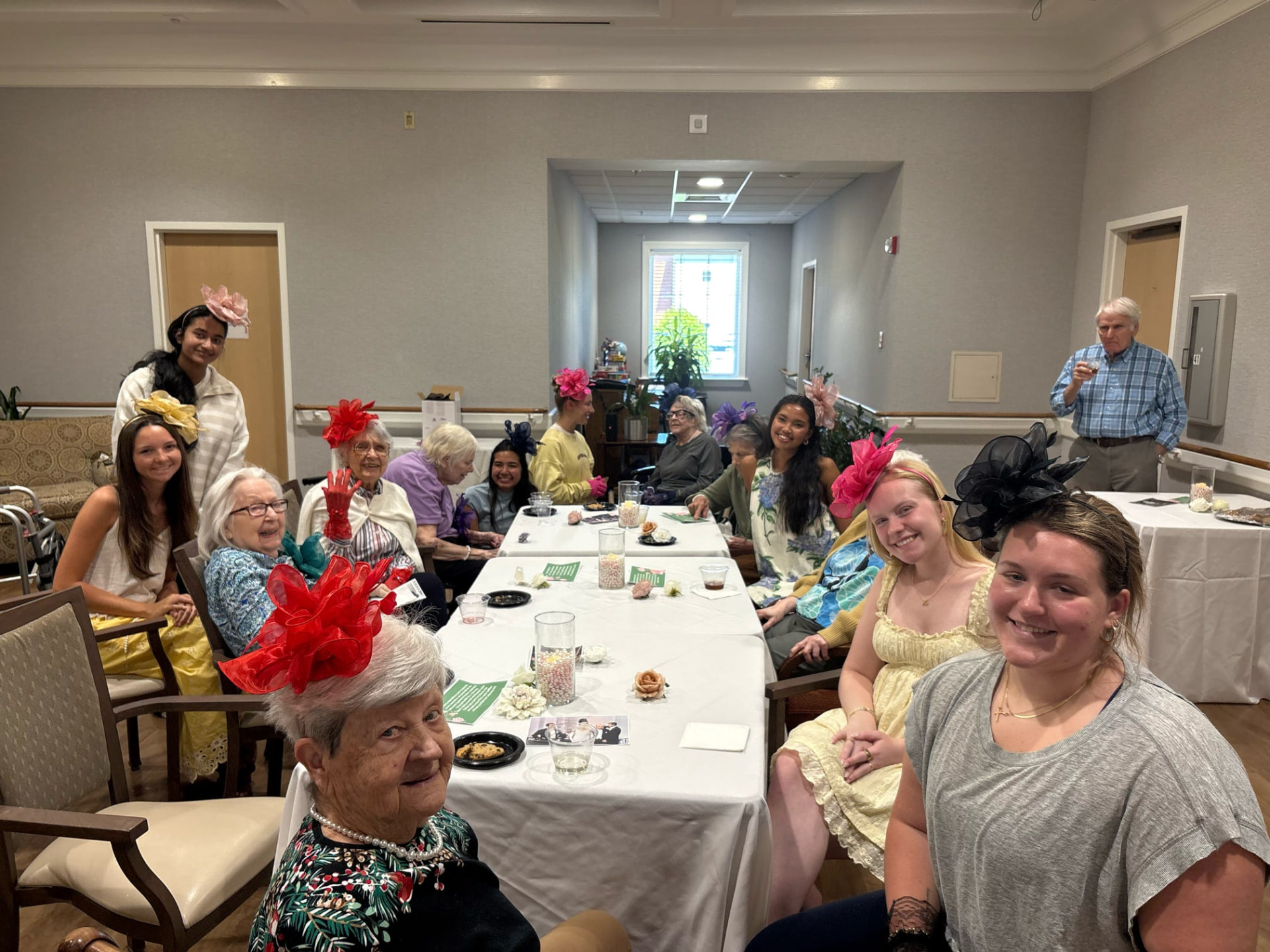 Members and residents at a derby-themed party