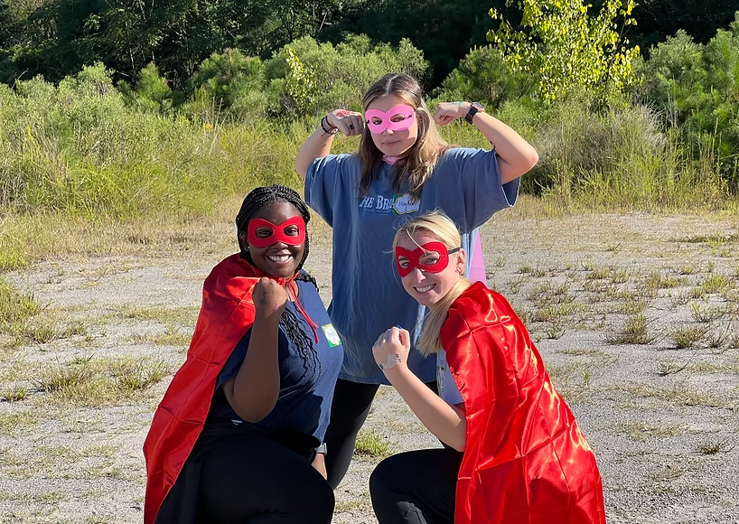Members dressed as superheroes at a community service event