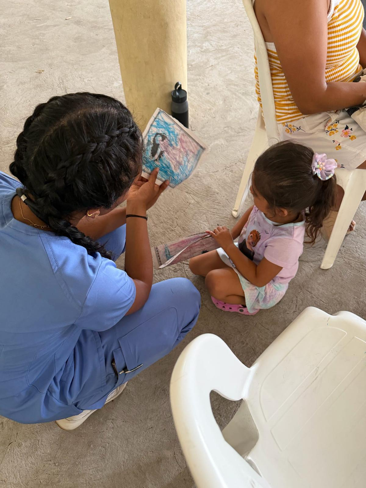 Member reading with a child at a clinic