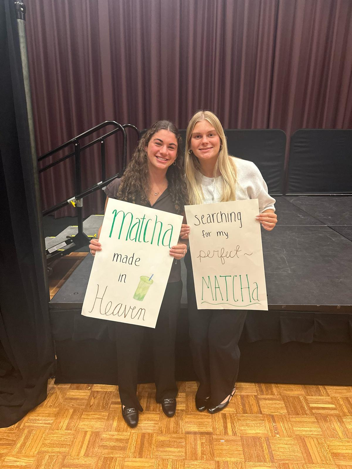 Members holding handmade signs at a chapter event