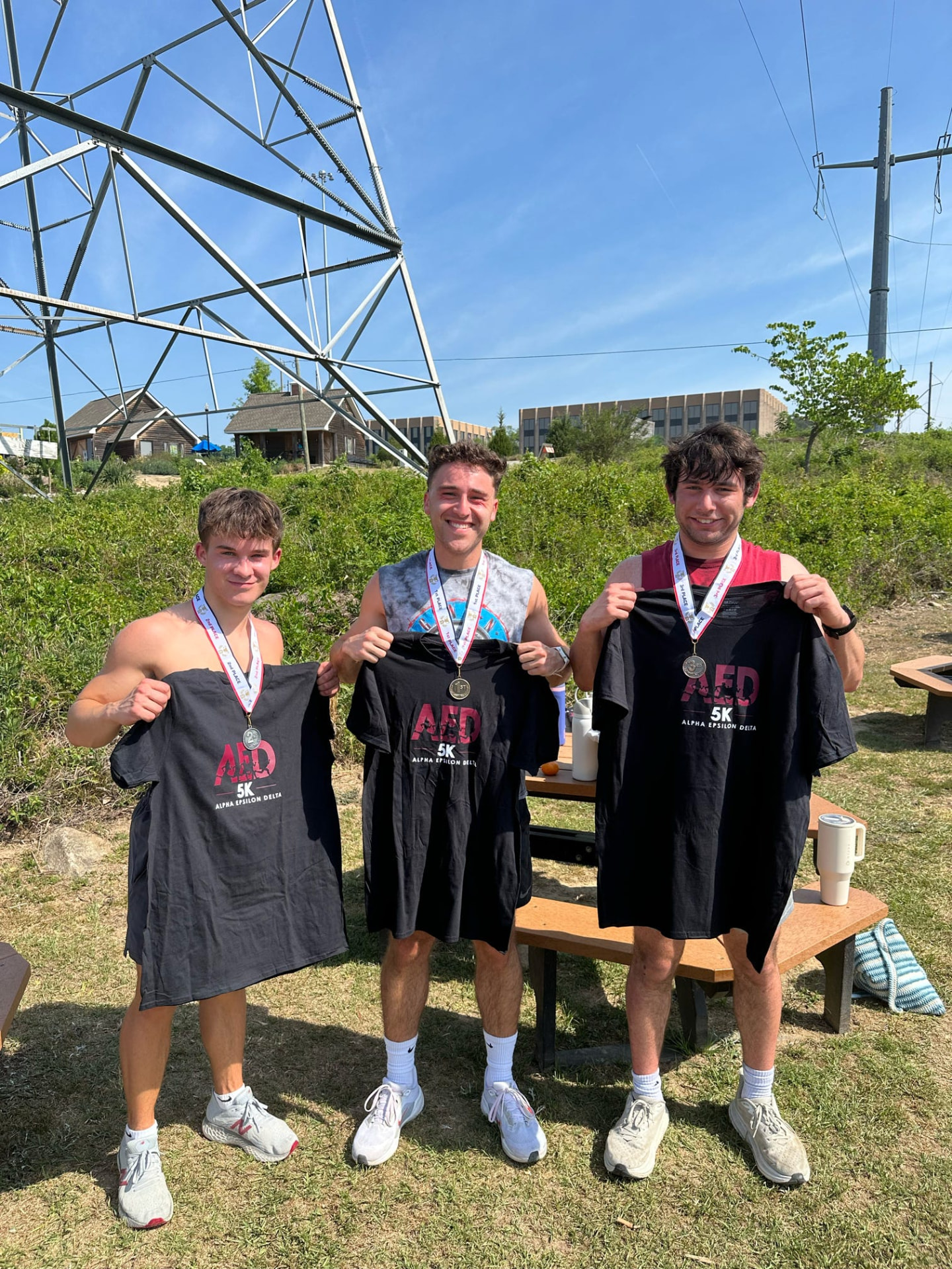 Top finishers with medals and shirts at the AED 5K